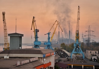 a view of a factory with smoke coming out of the stacks