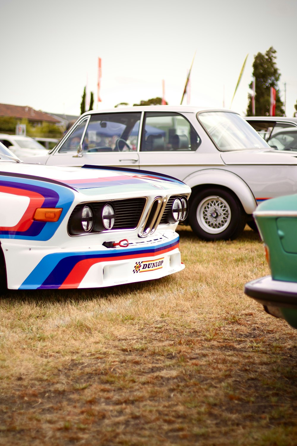 a group of cars parked next to each other on a field