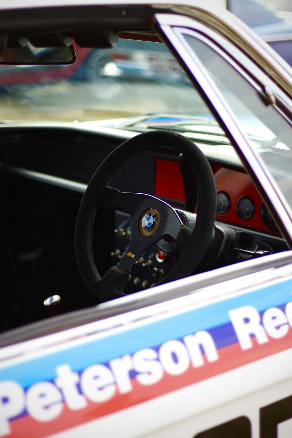 a person driving a car with a steering wheel