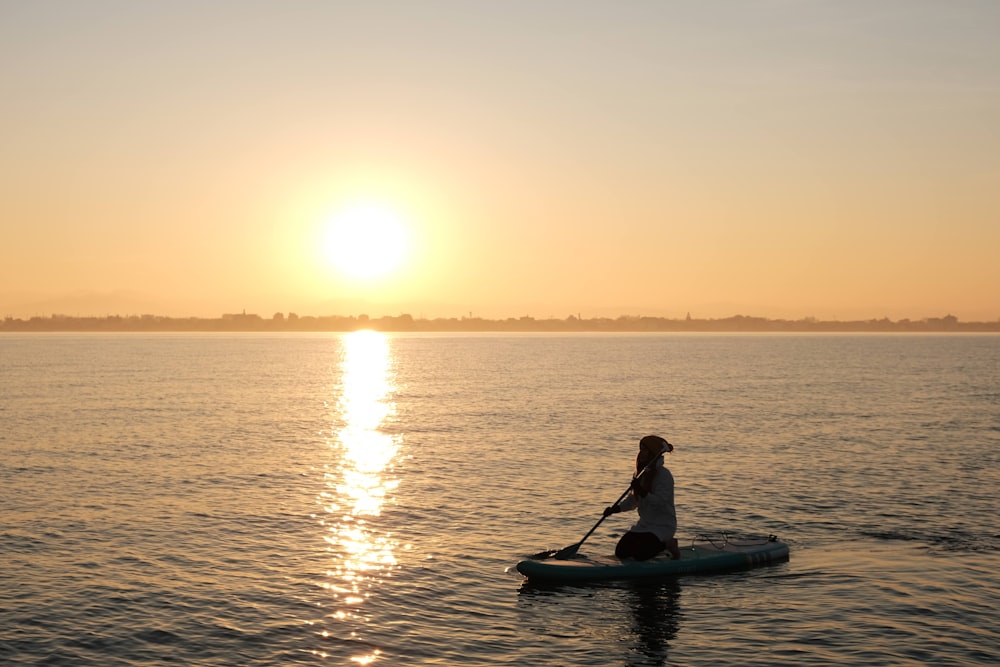 a person on a paddle board in the water