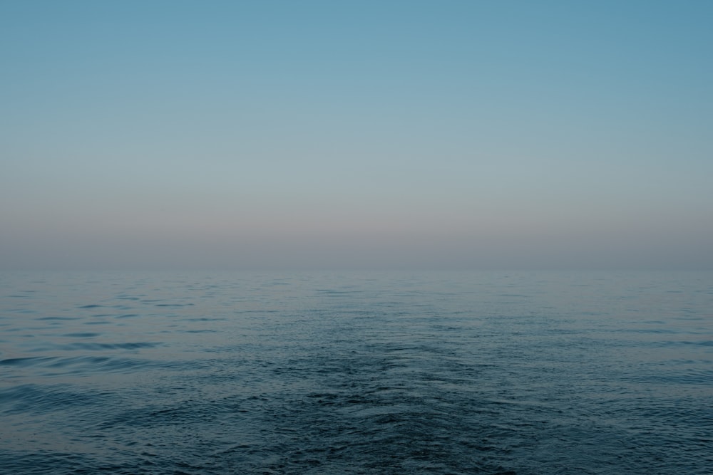 a body of water with a sky in the background