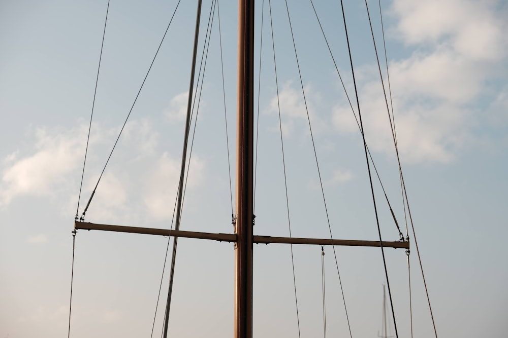 the mast of a sailboat against a blue sky