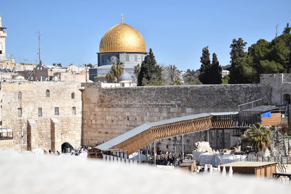 Ancient stone walls of Jerusalem's Old City beneath the golden Dome of the Rock