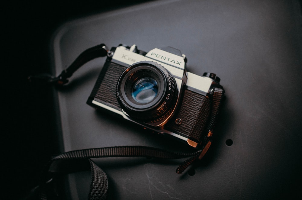 an old camera sitting on top of a table