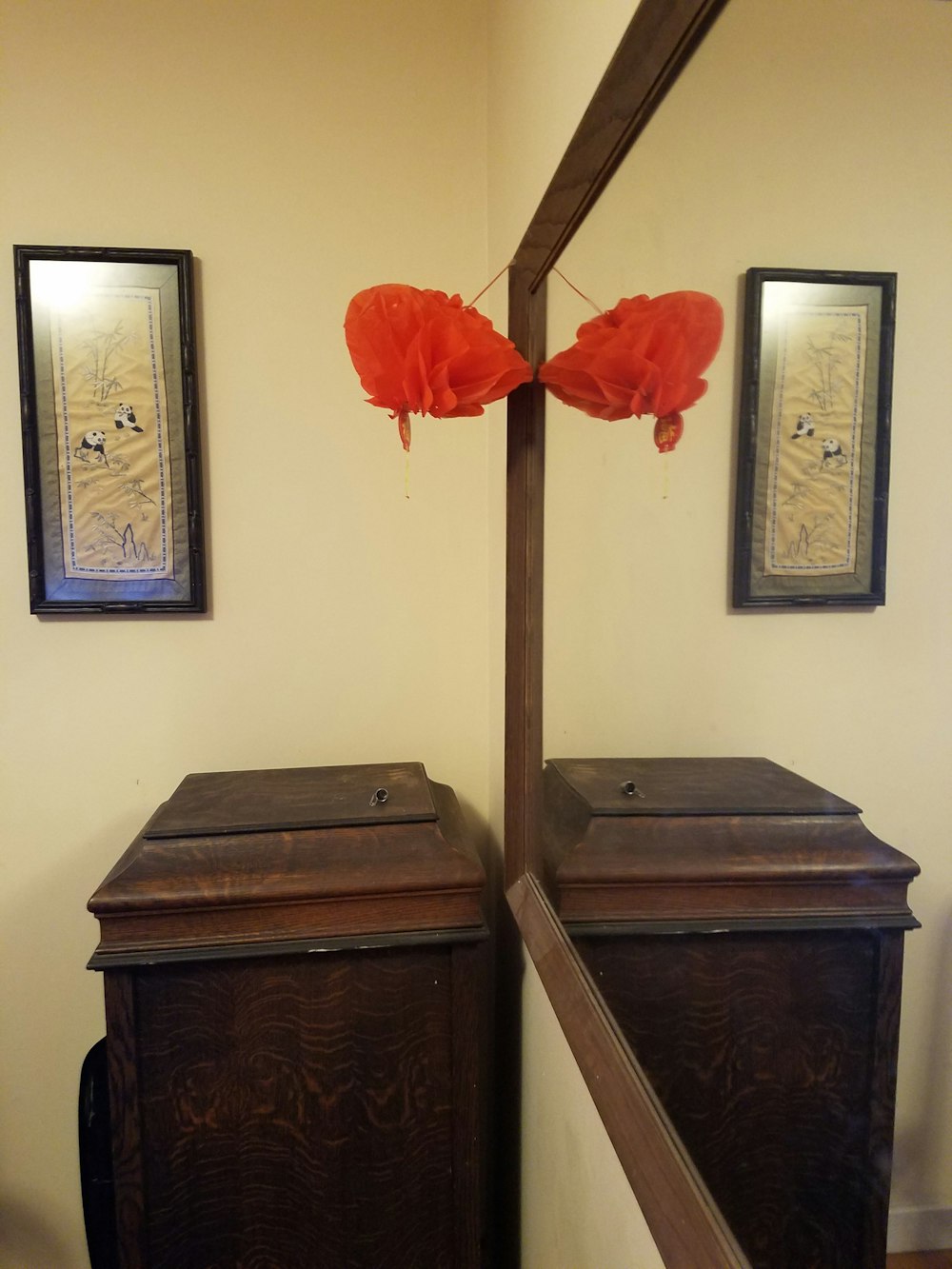 a room with a mirror and two wooden boxes