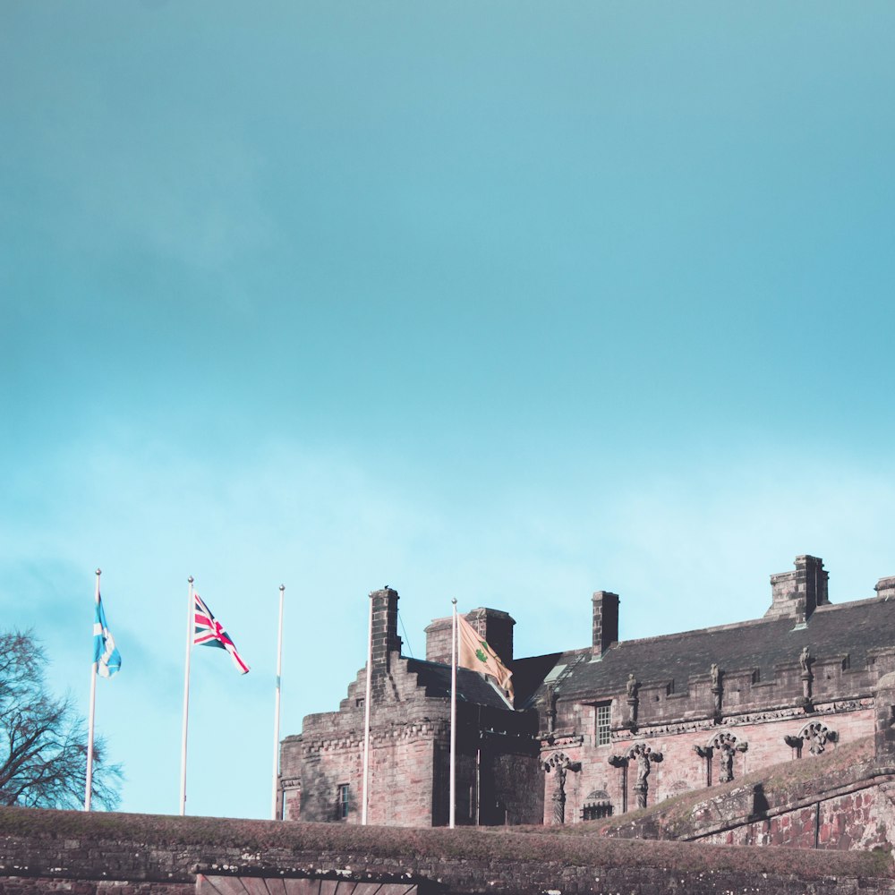 a castle with flags flying in front of it