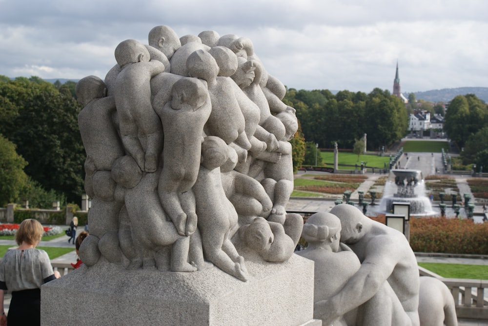 a group of people standing around a statue