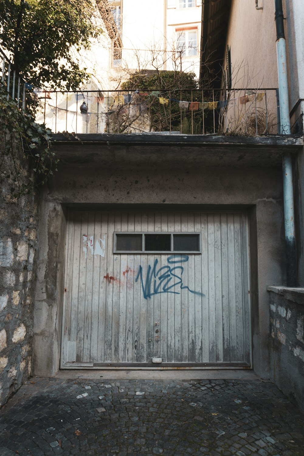 a garage door with graffiti on the side of it