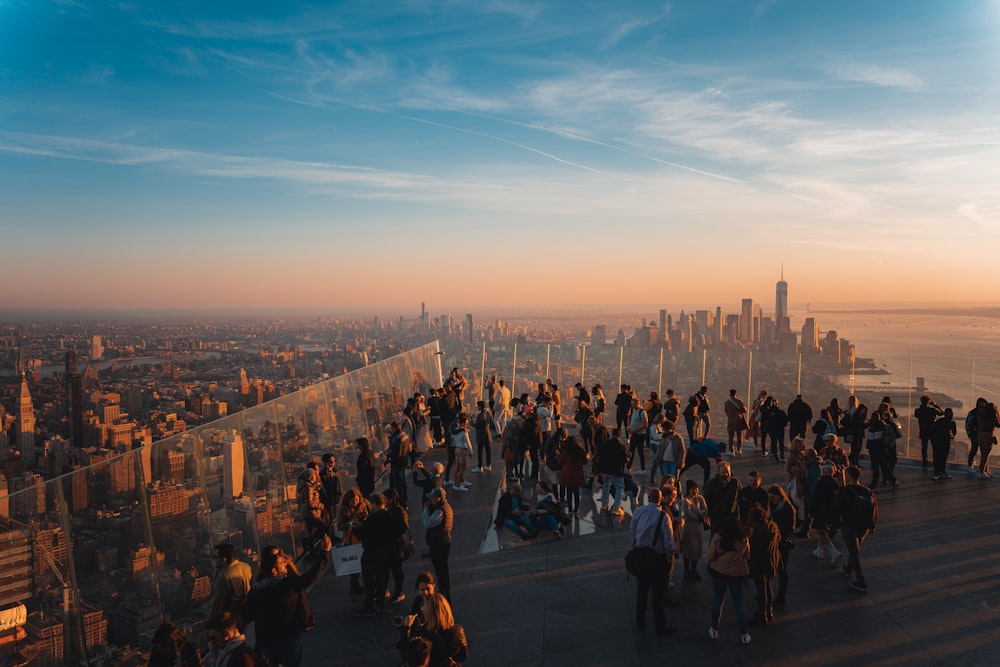 a group of people standing on top of a tall building