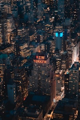 A nighttime aerial view of a well-lit, bustling commercial district.
