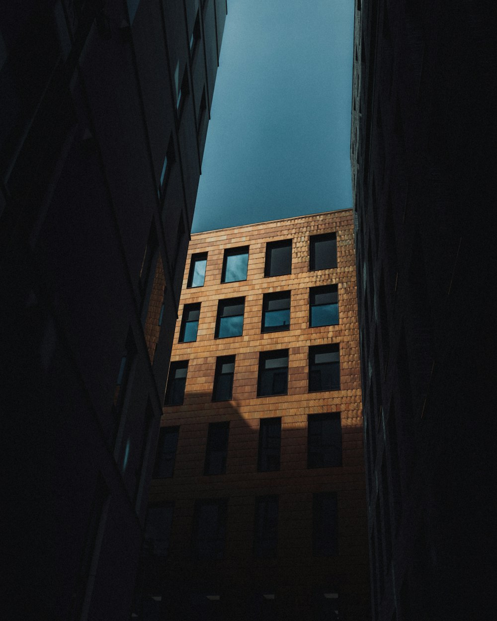 a tall brick building with a sky background