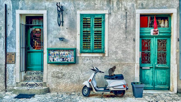 Green shutters and a scooter in a lane — Rovinj, Croatia