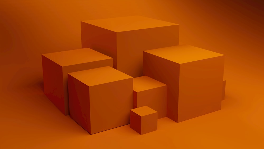 a group of orange boxes sitting on top of a table
