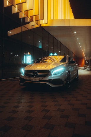 a car parked in front of a building at night