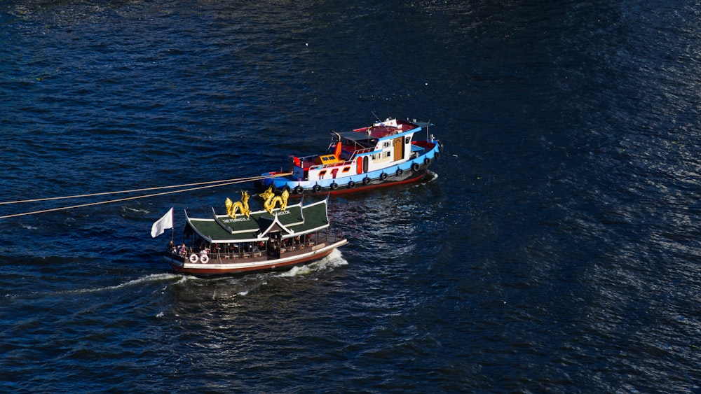 a couple of boats floating on top of a body of water