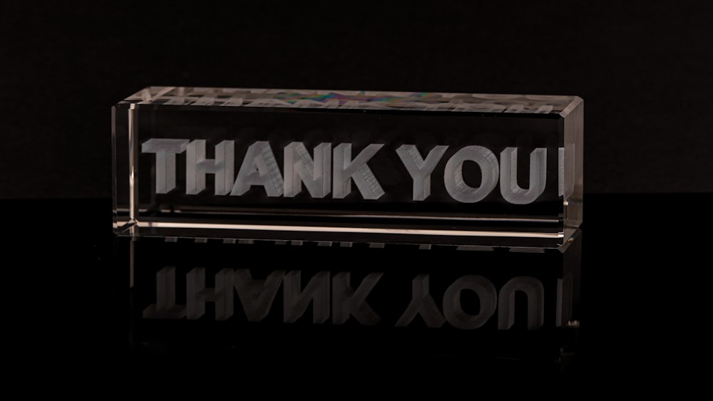 a glass block with the words thank you on it