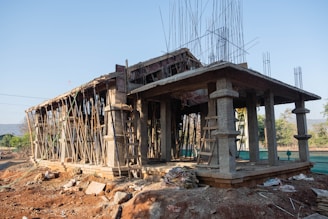 a wooden structure sitting on top of a dirt field