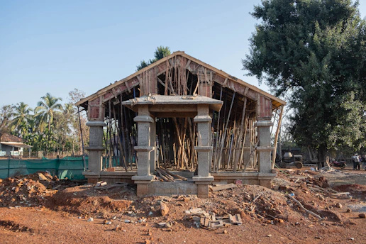 a wooden structure sitting on top of a dirt field