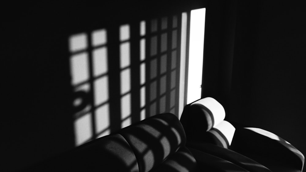 a black and white photo of a room with a window