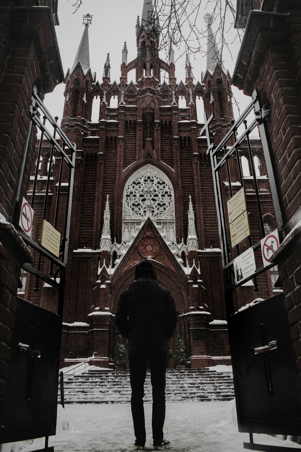 a man standing in front of a large building