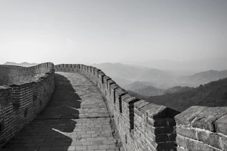 a black and white photo of the great wall of china