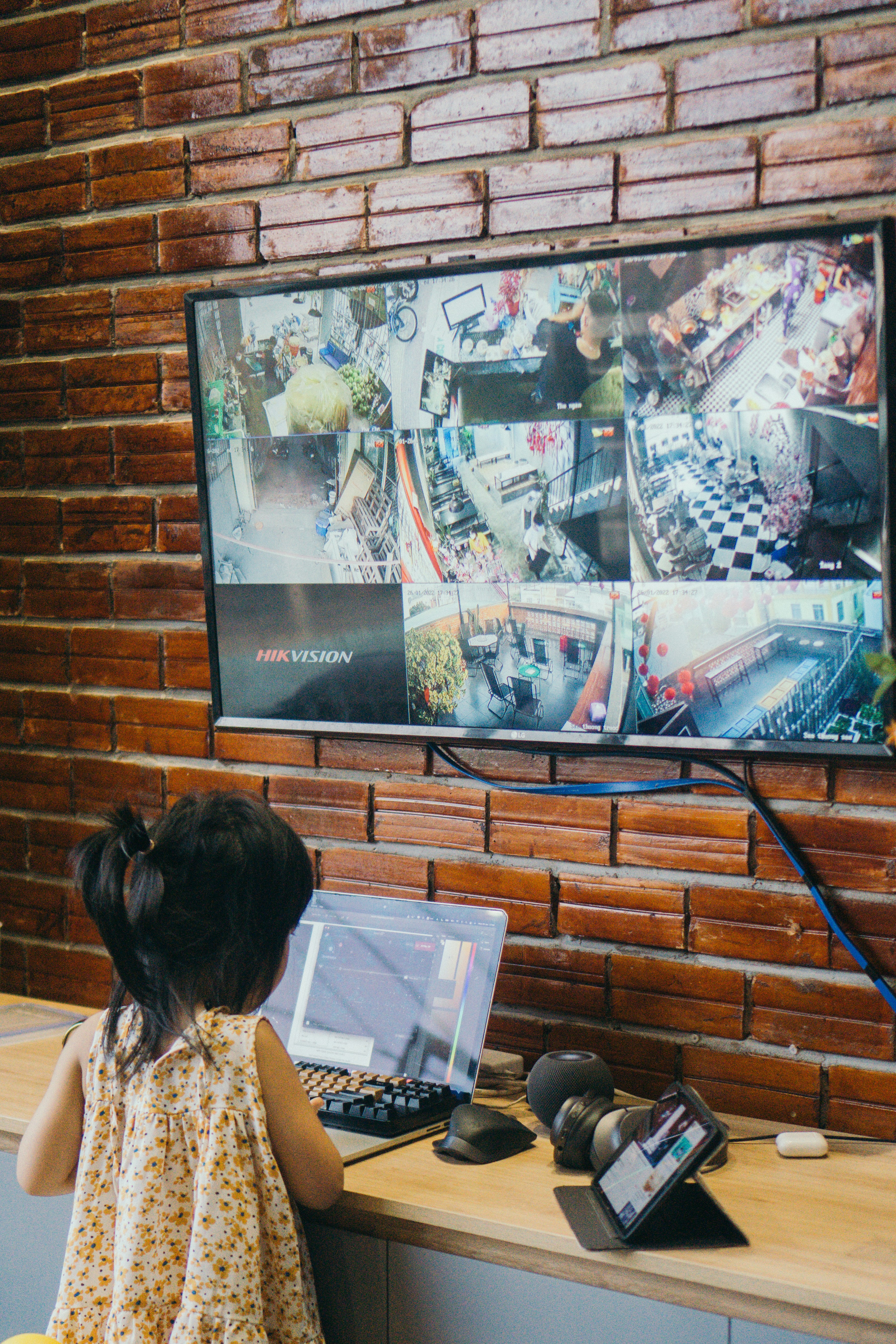 a little girl sitting in front of a laptop computer
