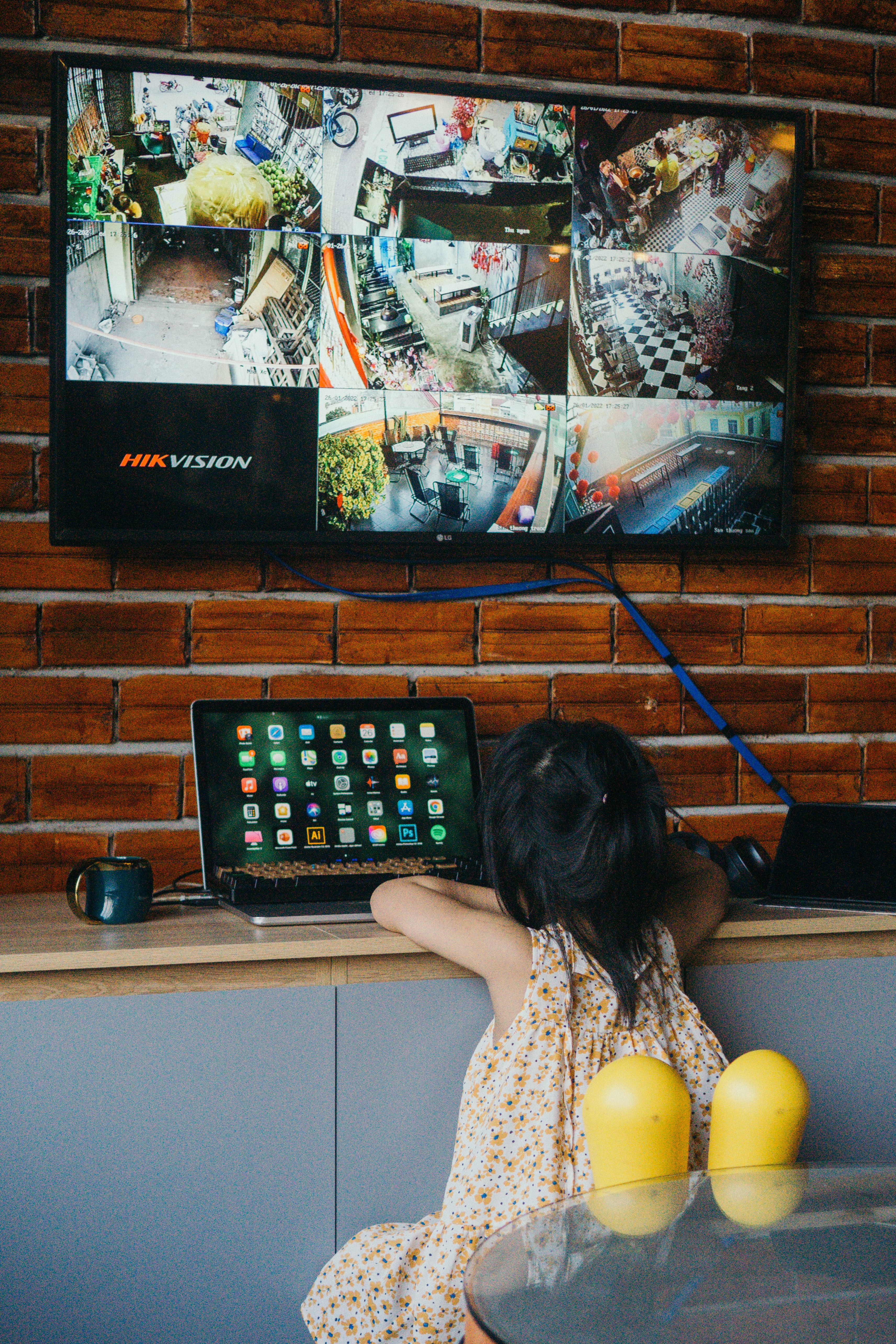 a little girl sitting in front of a laptop computer