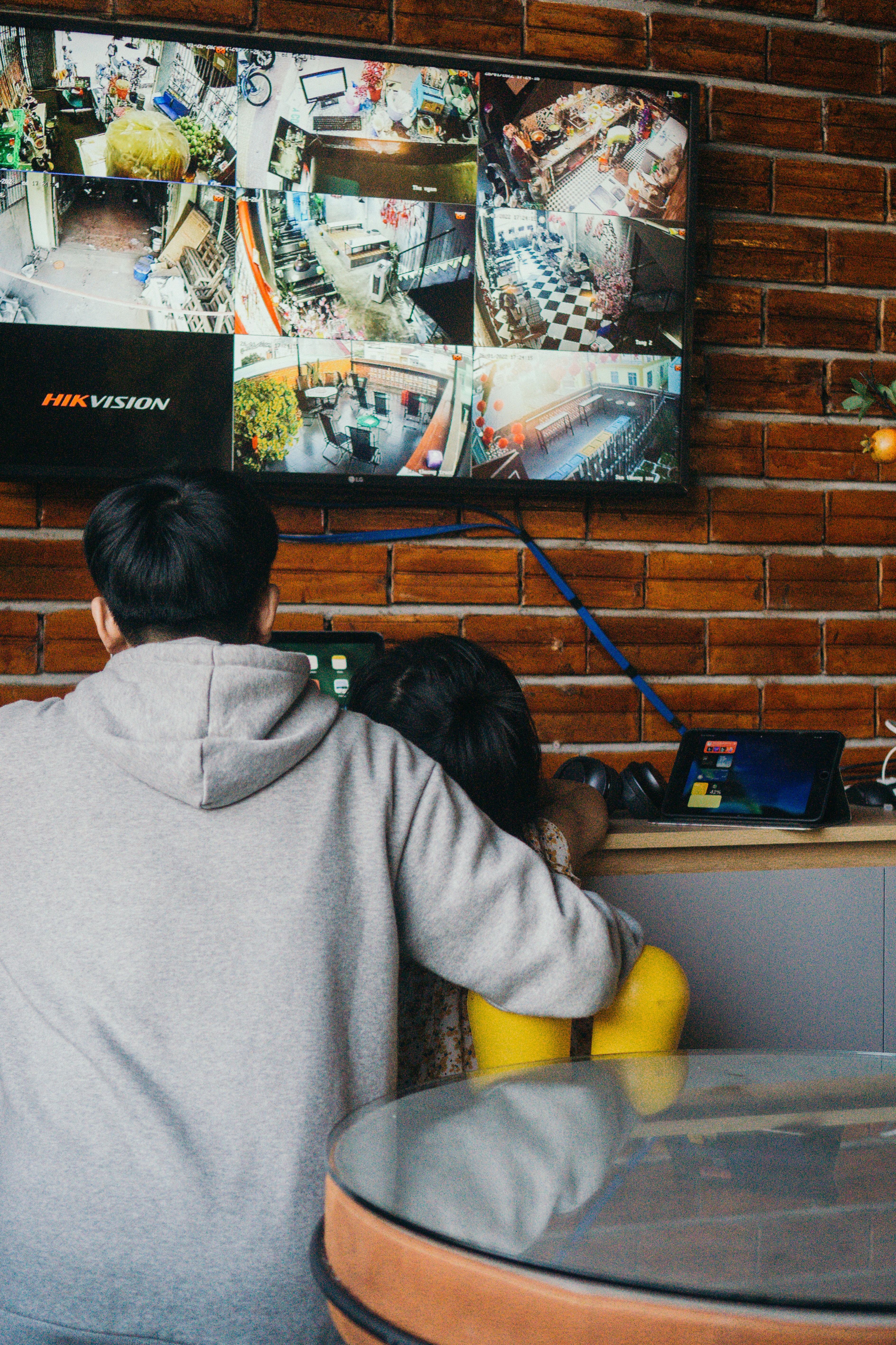 a couple of people sitting at a table in front of a tv