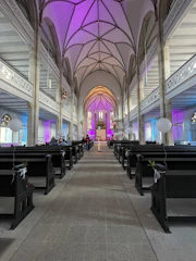 Elegant church entrance decorated with soft ivory and light blue floral arrangements.