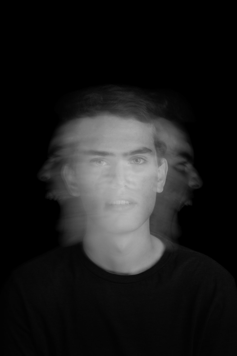 a blurry photo of a man in a black shirt