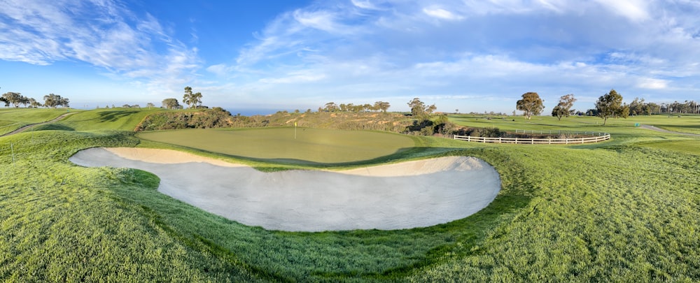 an aerial view of a golf course with a sand trap