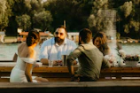 Group of doctors enjoying a casual outdoor discussion by the water.