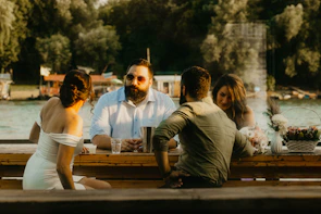 Group of doctors enjoying a casual outdoor discussion by the water.
