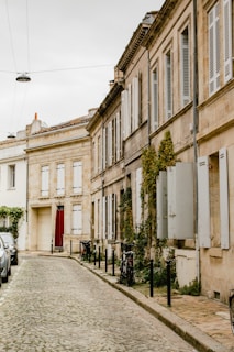 a person walking down a sidewalk next to a building