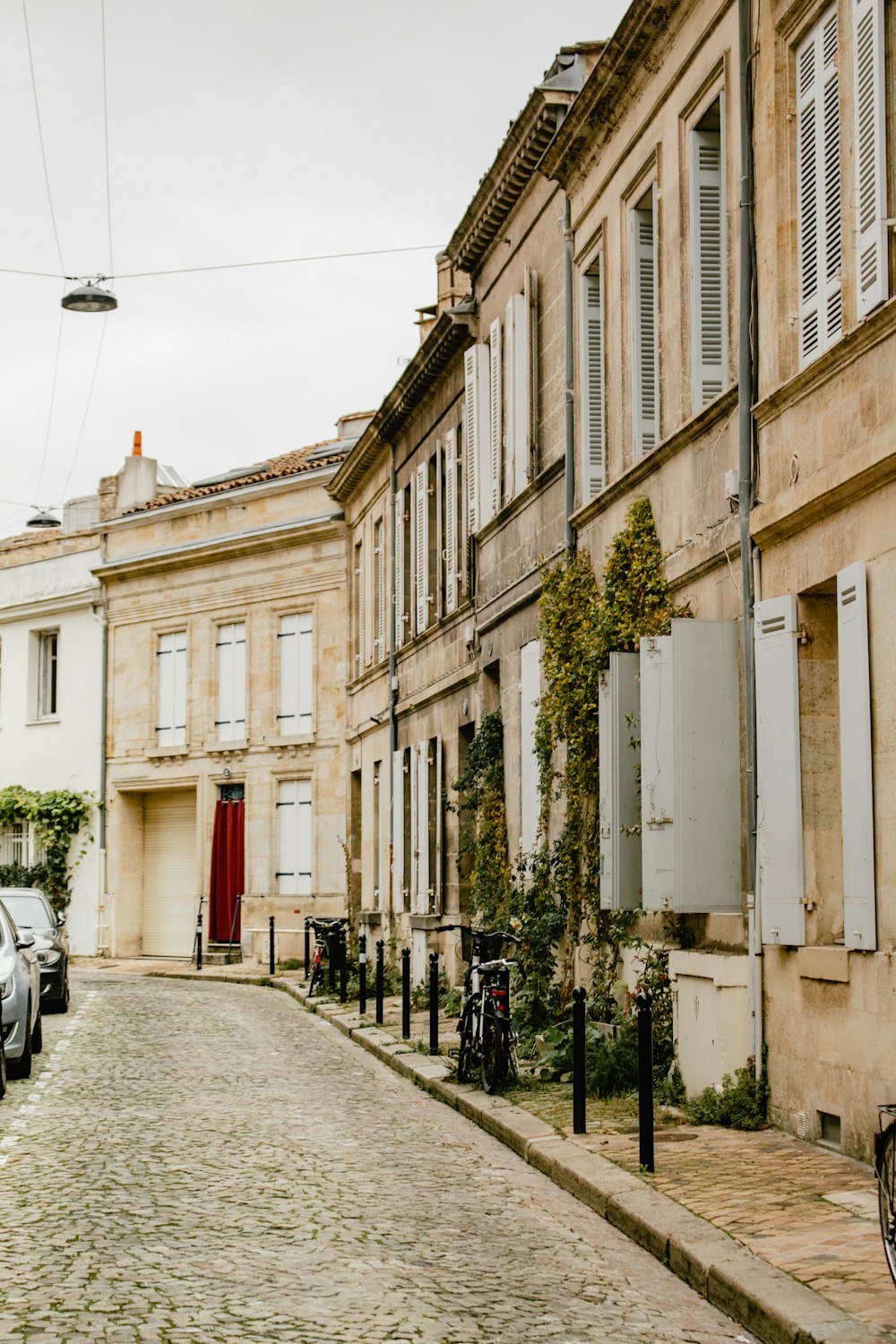 a person walking down a sidewalk next to a building