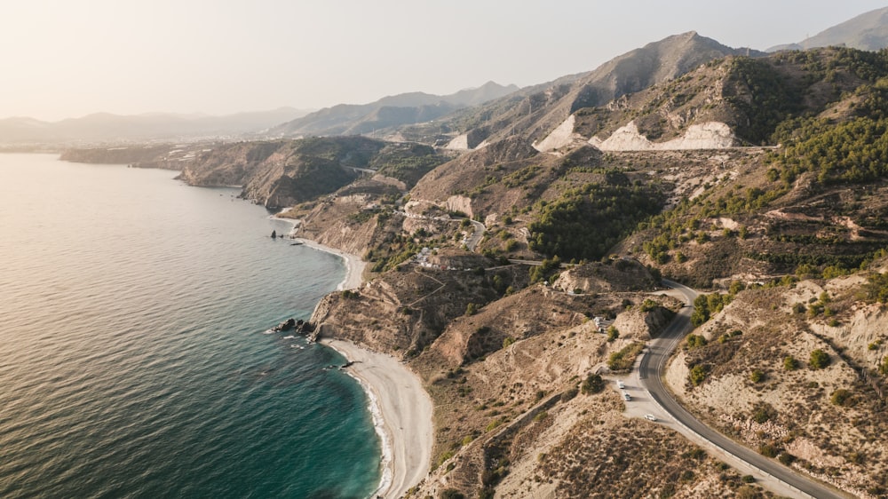 an aerial view of a road on the side of a mountain