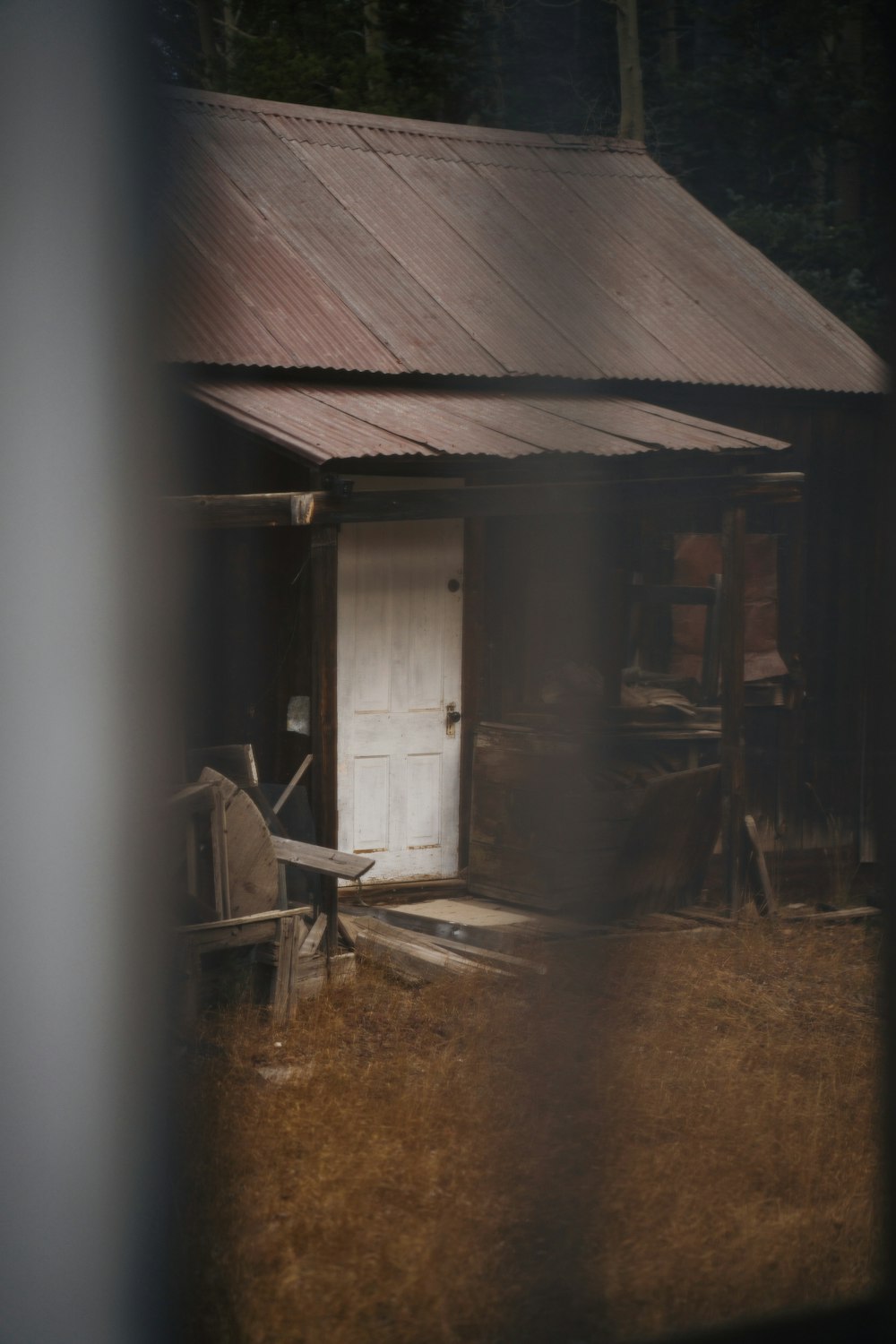 a house with a door and a chair in front of it