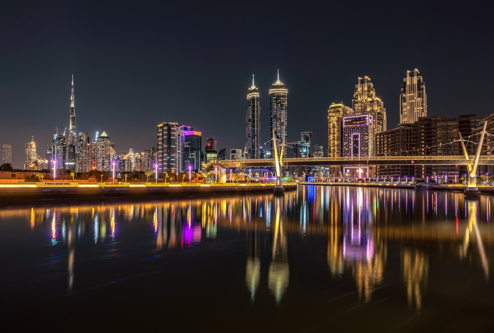 a city skyline is reflected in the water