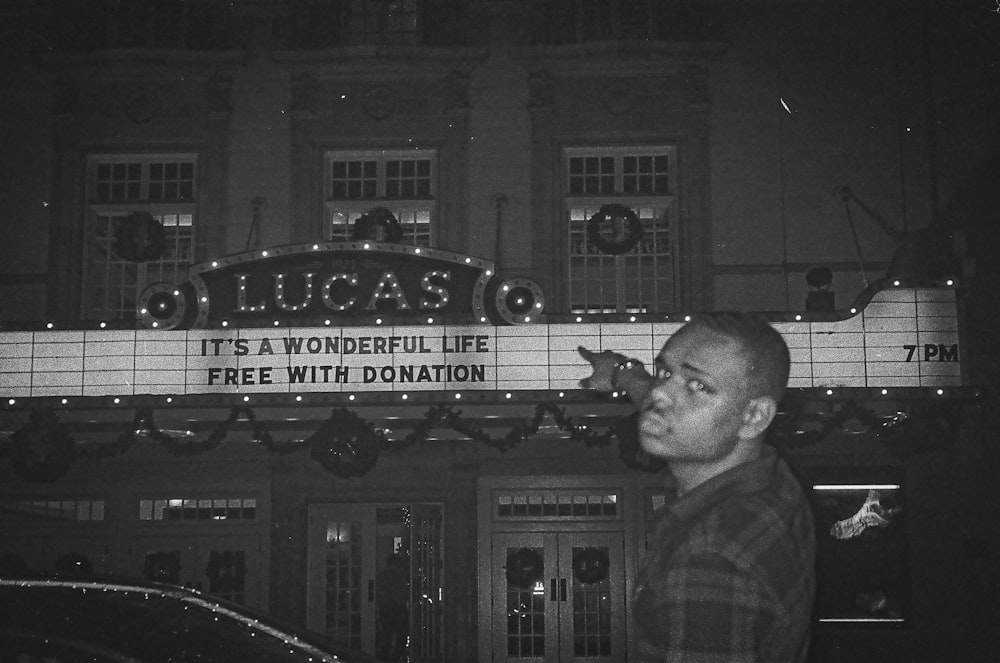 a man standing in front of a theater
