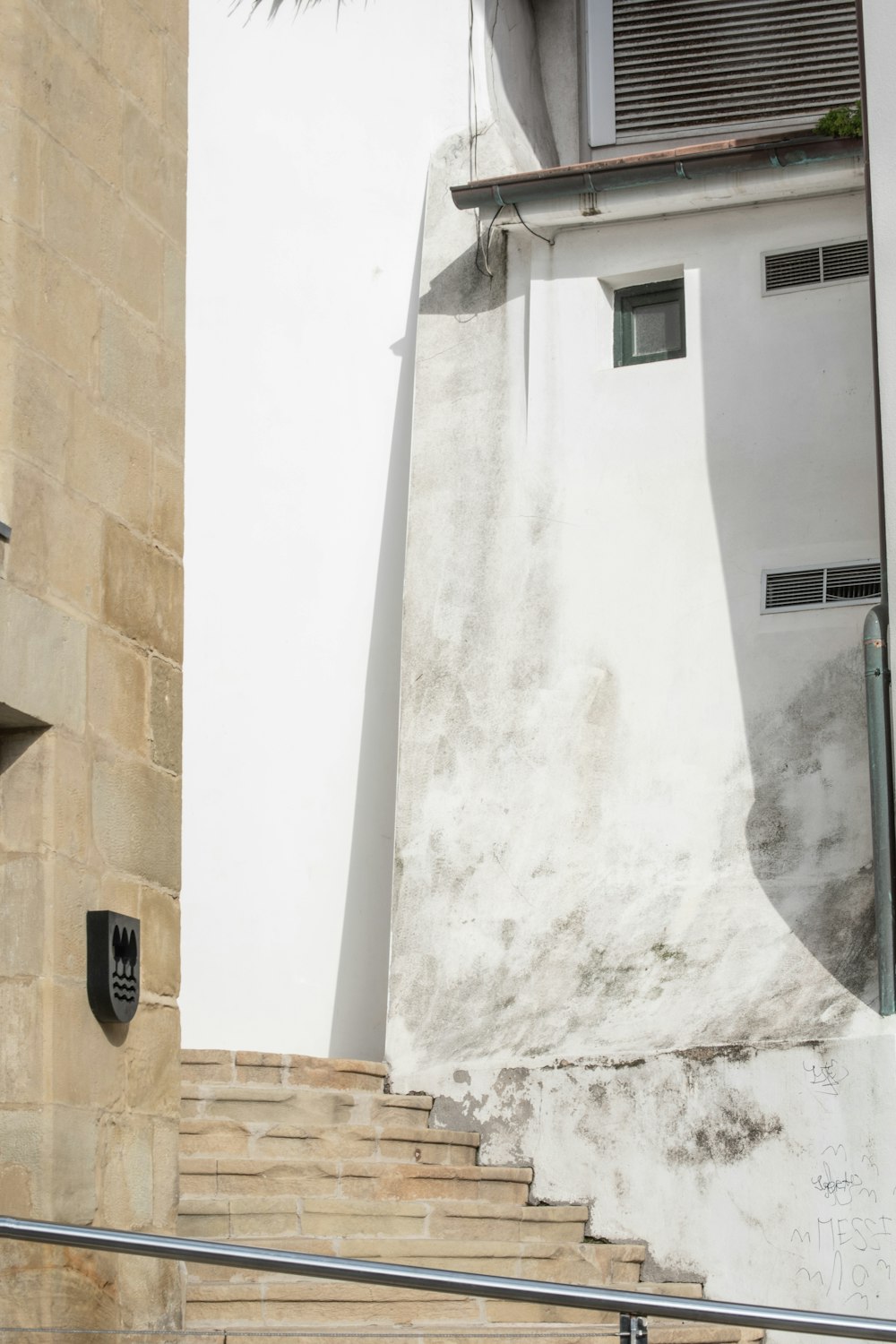 a white building with a door and some stairs