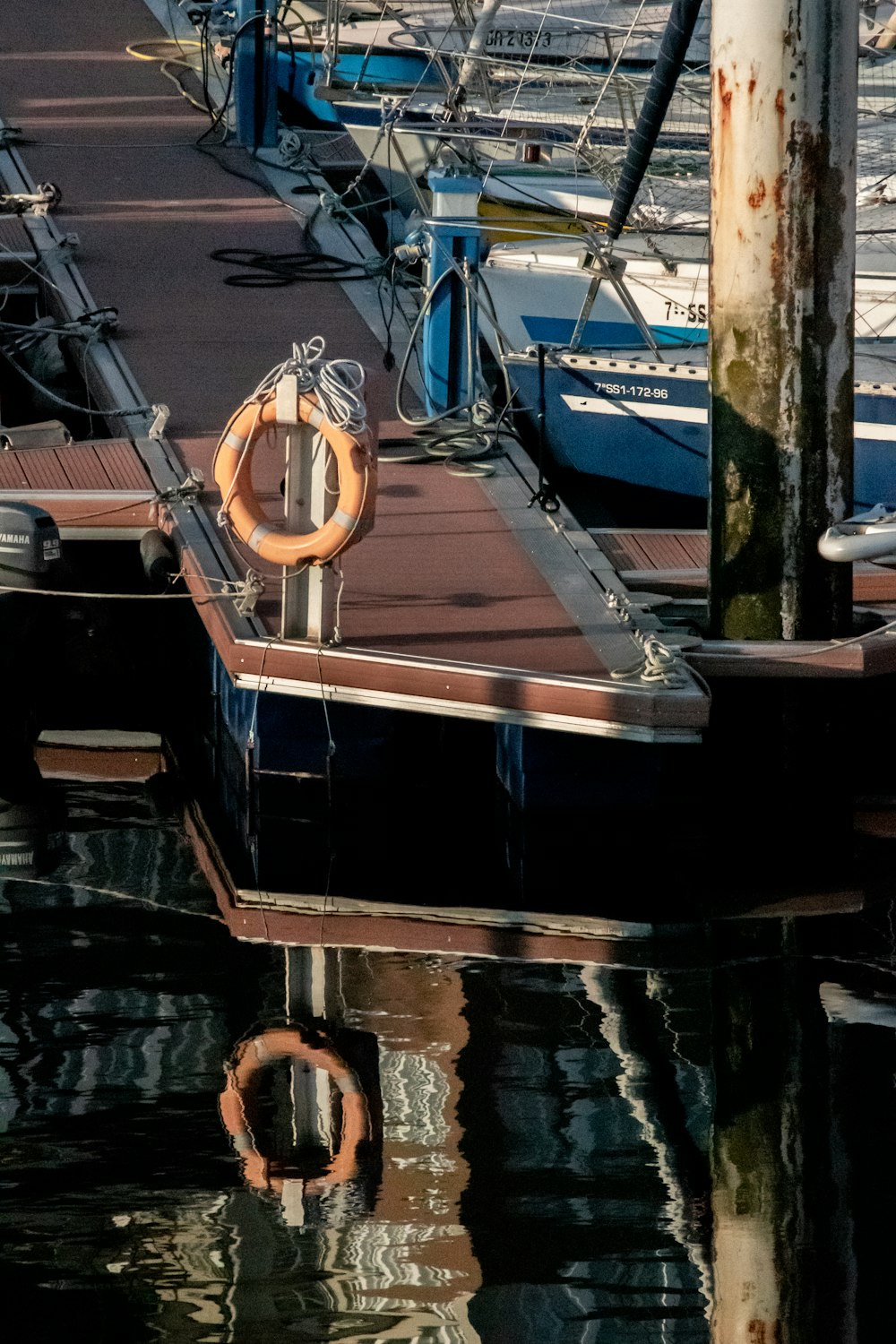 a boat docked at a dock with other boats in the water