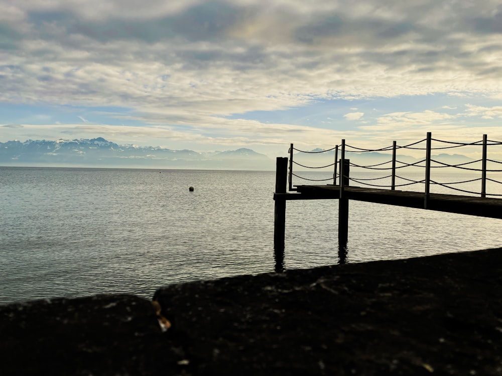 a wooden dock sitting on top of a body of water