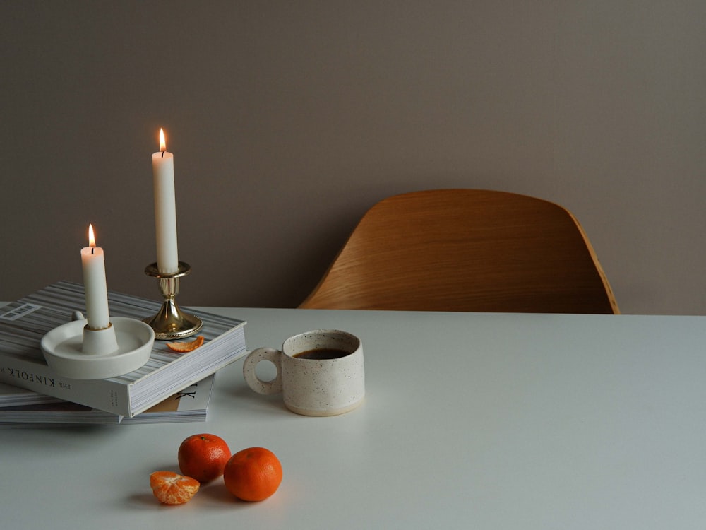 a couple of candles sitting on top of a table