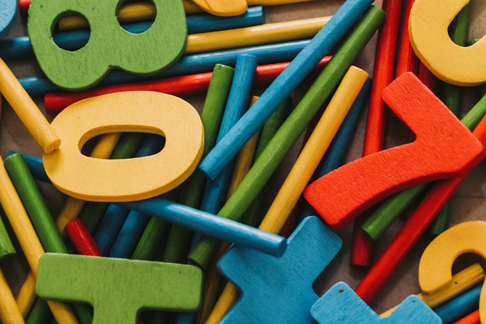 a pile of colorful wooden letters and numbers