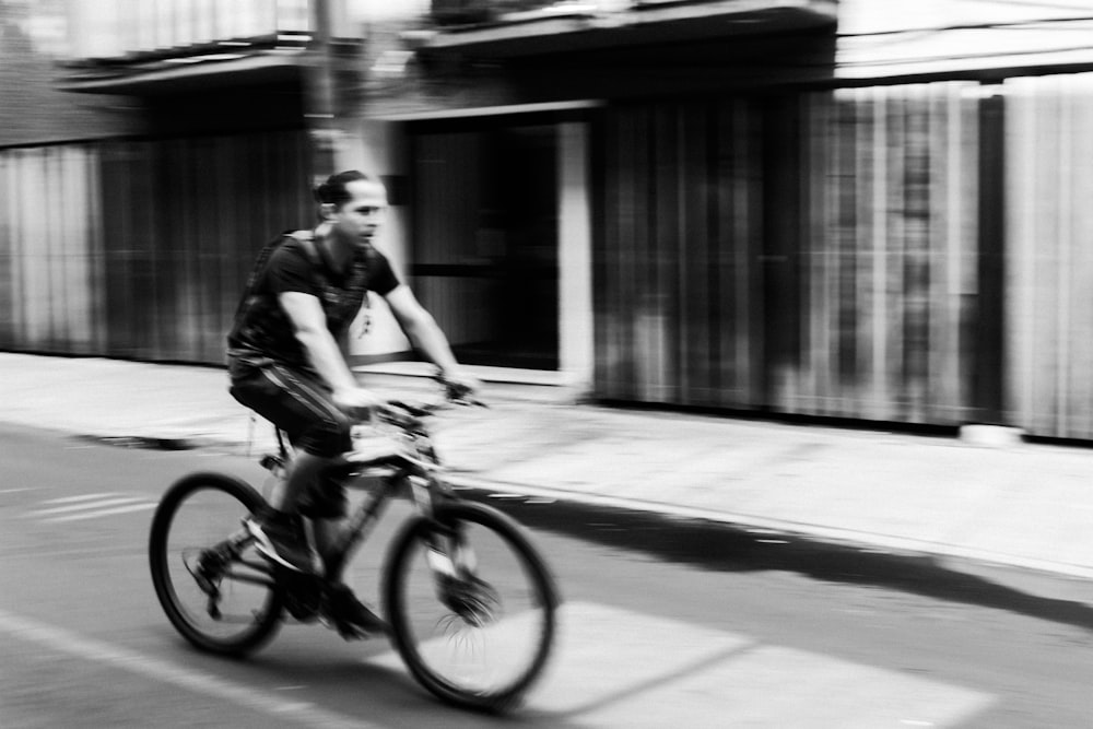 a man riding a bike down a street