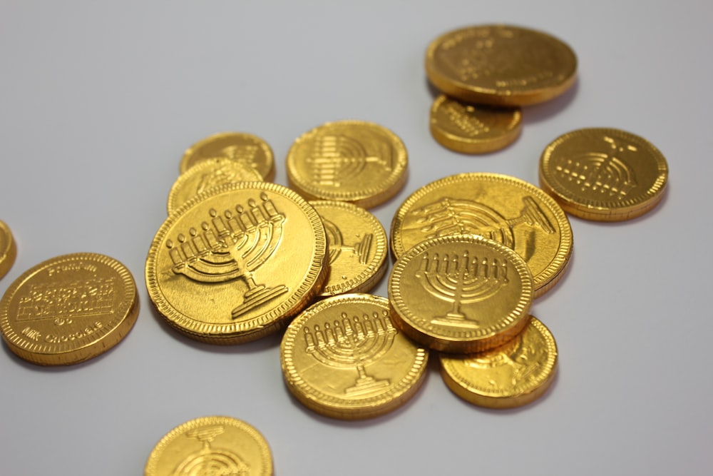 a pile of gold coins sitting on top of a table