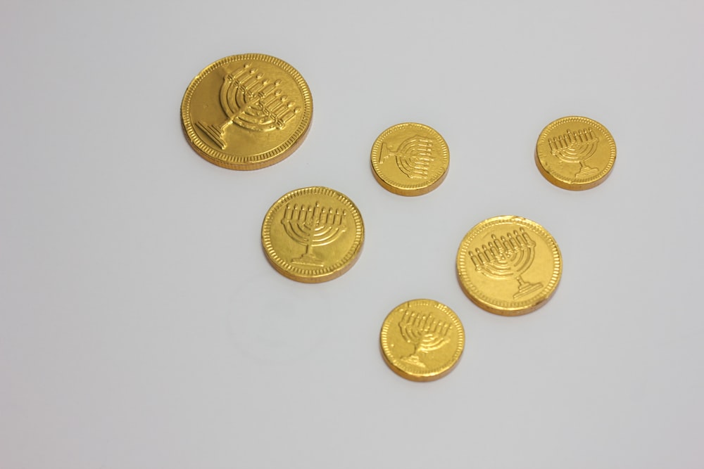a bunch of gold coins sitting on top of a table