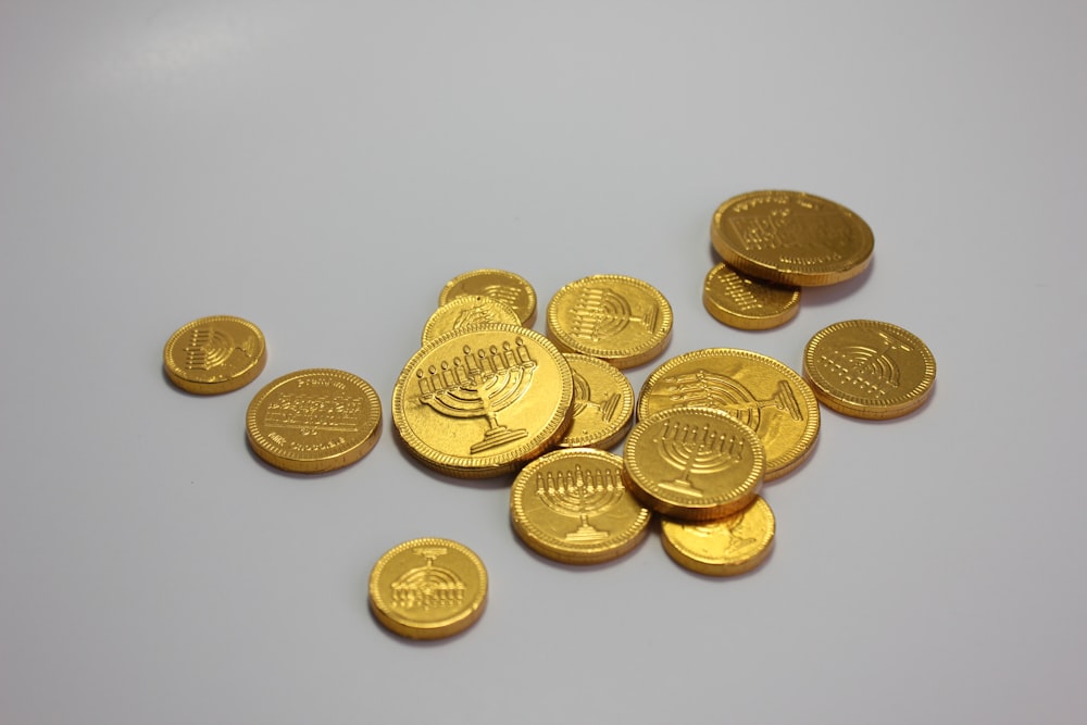 a pile of gold coins sitting on top of a table