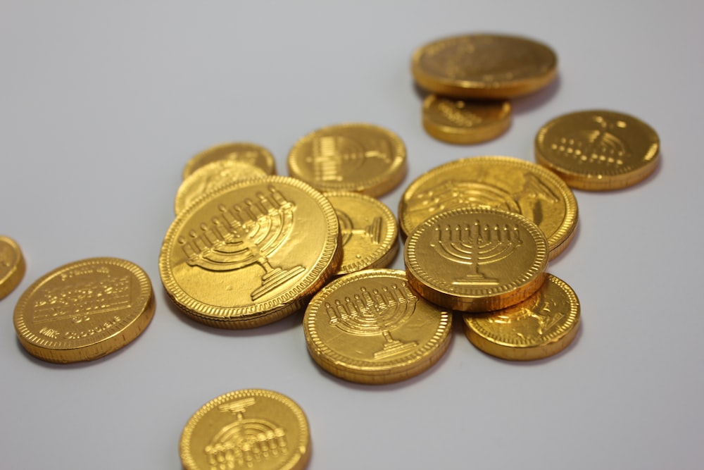 a pile of gold coins sitting on top of a table