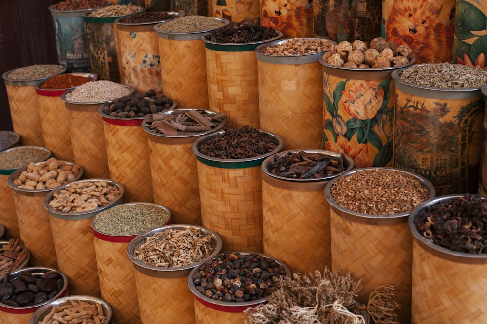 a bunch of tins filled with different types of nuts